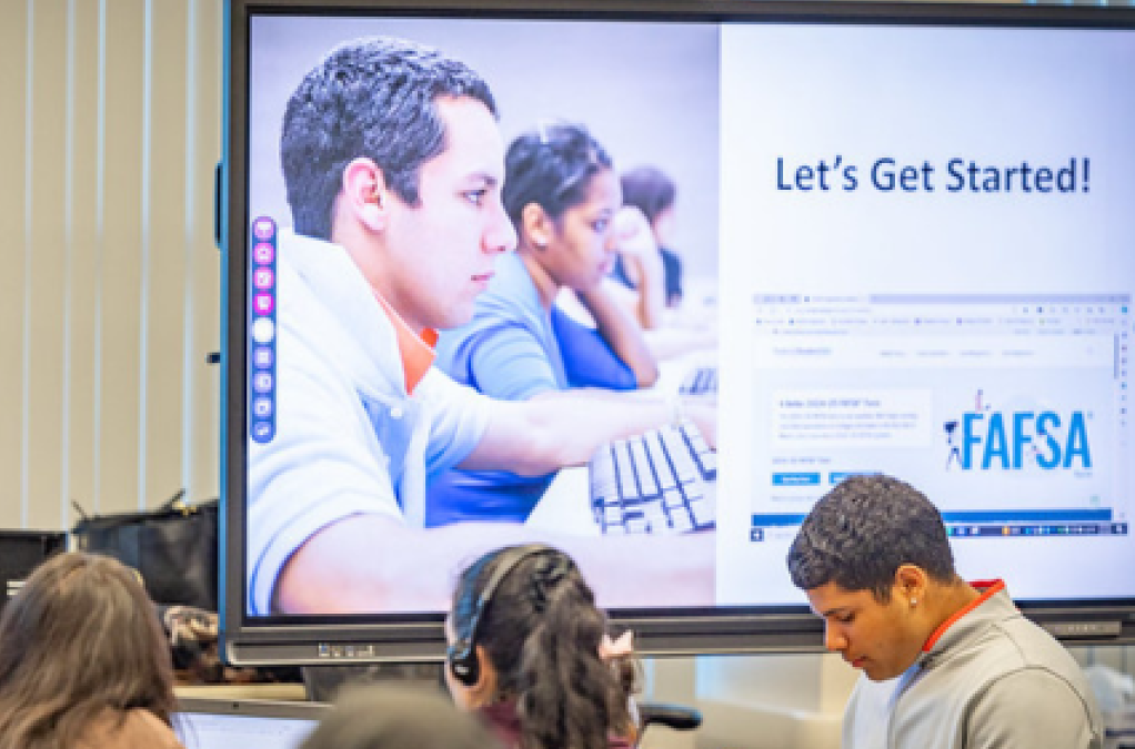 Students complete financial aid forms on computers as they prepare to submit the FAFSA.